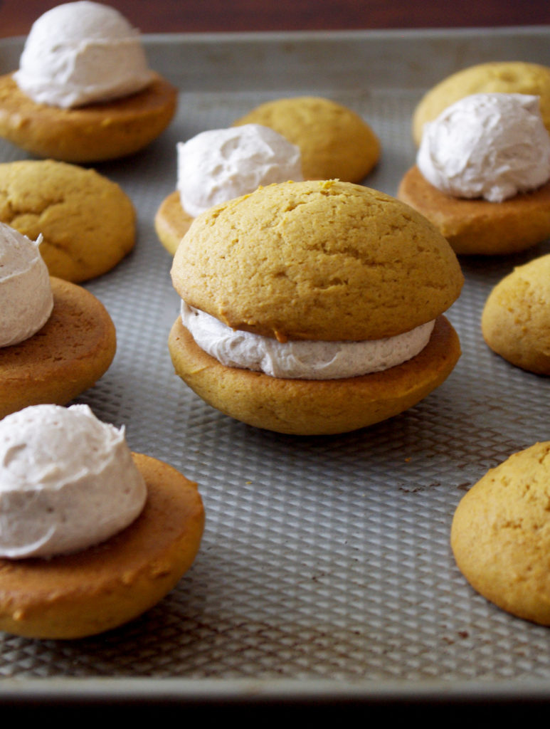 Pumpkin Whoopie Pies with Whipped Cinnamon Filling are soft, pillowy bundles of cinnamon sweetness and pumpkin goodness | www.thebatterthickens.com