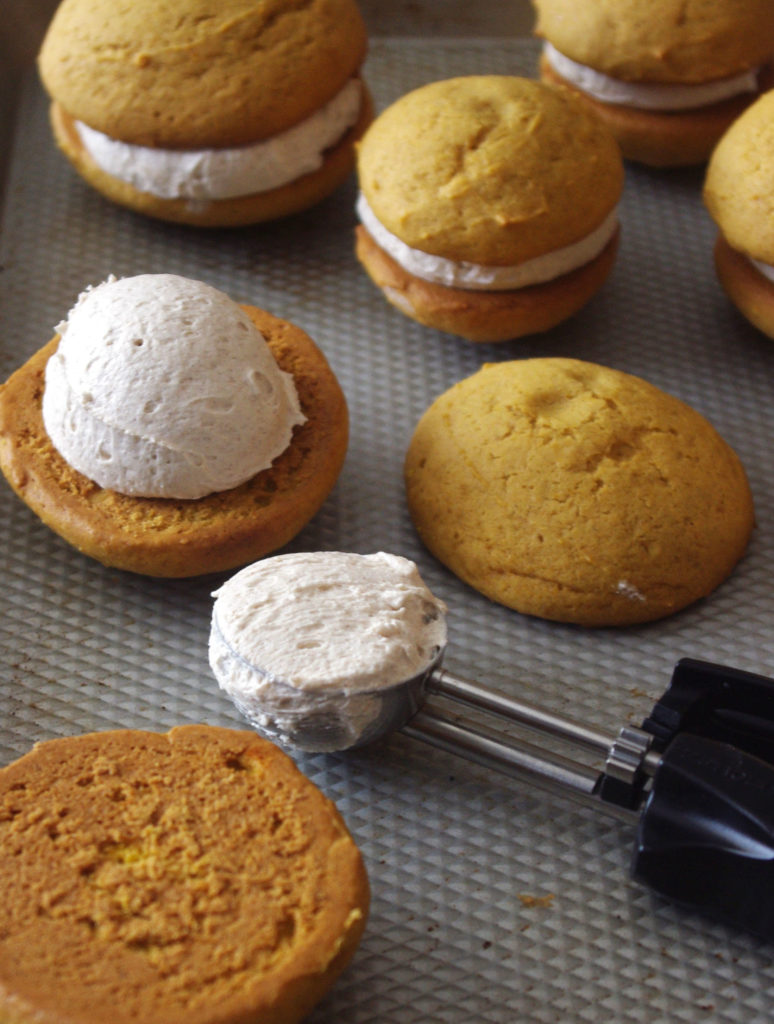 Pumpkin Whoopie Pies with Whipped Cinnamon Filling are soft, pillowy bundles of cinnamon sweetness and pumpkin goodness | www.thebatterthickens.com