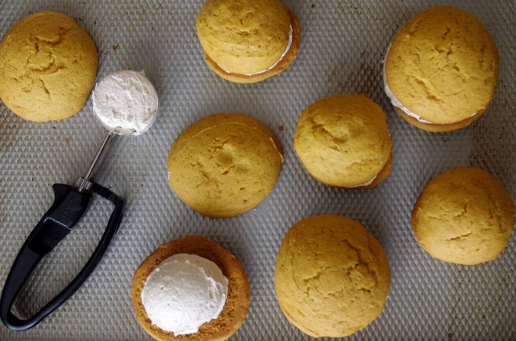 Pumpkin Whoopie Pies with Whipped Cinnamon Filling are soft, pillowy bundles of cinnamon sweetness and pumpkin goodness | www.thebatterthickens.com