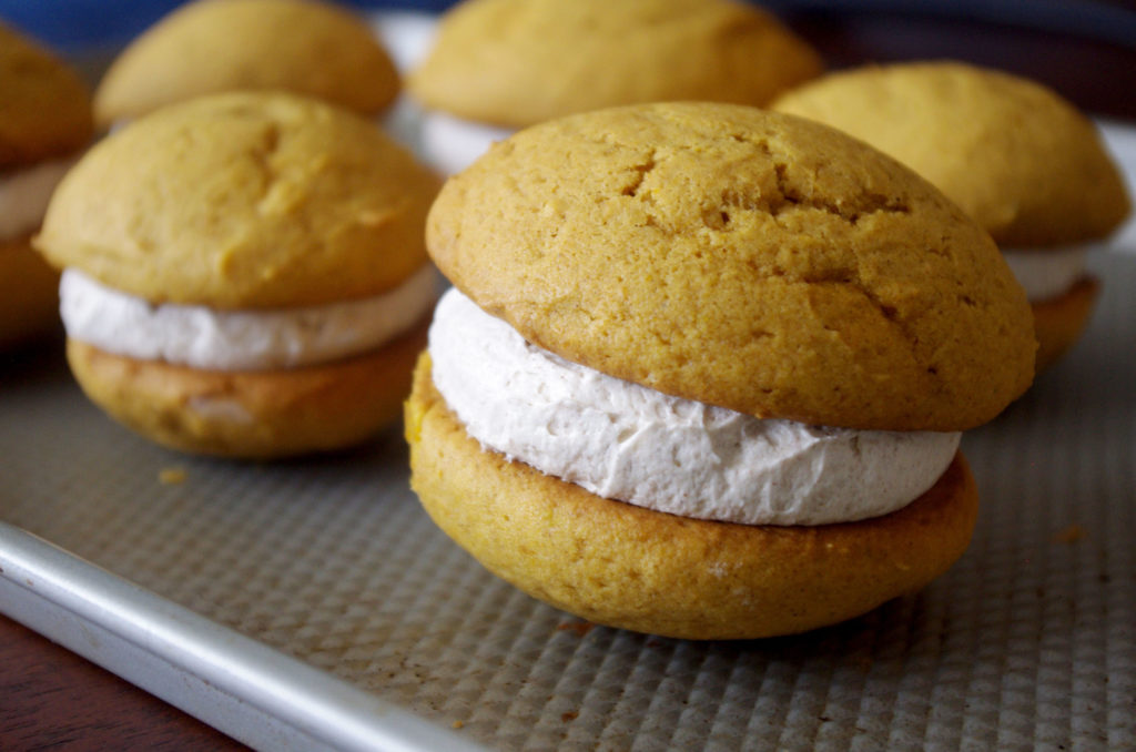 Pumpkin Whoopie Pies with Whipped Cinnamon Filling are soft, pillowy bundles of cinnamon sweetness and pumpkin goodness | www.thebatterthickens.com