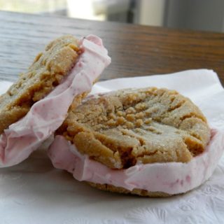 Peanut Butter and Jelly Ice Cream Sandwiches - sweet strawberry ice cream sandwiched between two peanut butter cookies #icecreamsandwich #peanutbutterandjelly | www.thebatterthickens.com