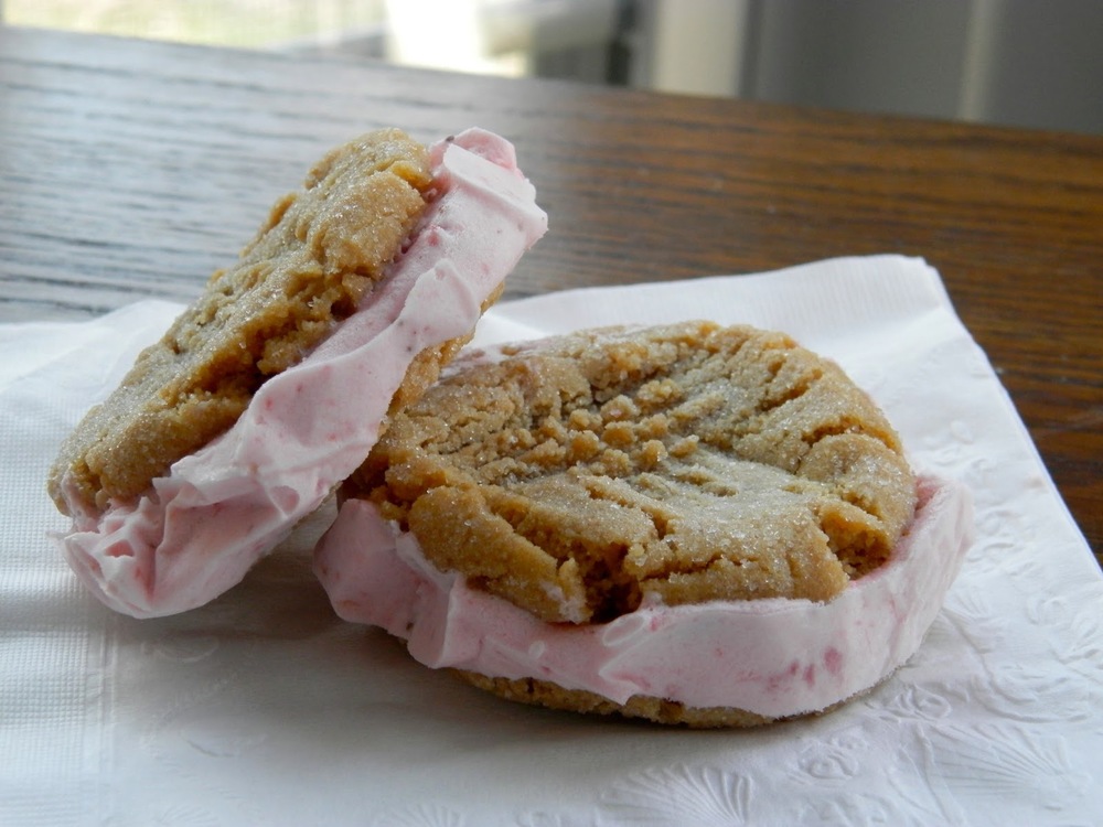 Peanut Butter and Jelly Ice Cream Sandwiches - sweet strawberry ice cream sandwiched between two peanut butter cookies #icecreamsandwich #peanutbutterandjelly | www.thebatterthickens.com