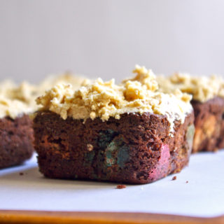 Monster Cookie Brownies - stuffed with peanut butter chips and M&Ms, and covered in peanut butter oatmeal cookie dough frosting #peanutbutter #monstercookies #brownies | www.thebatterthickens.com