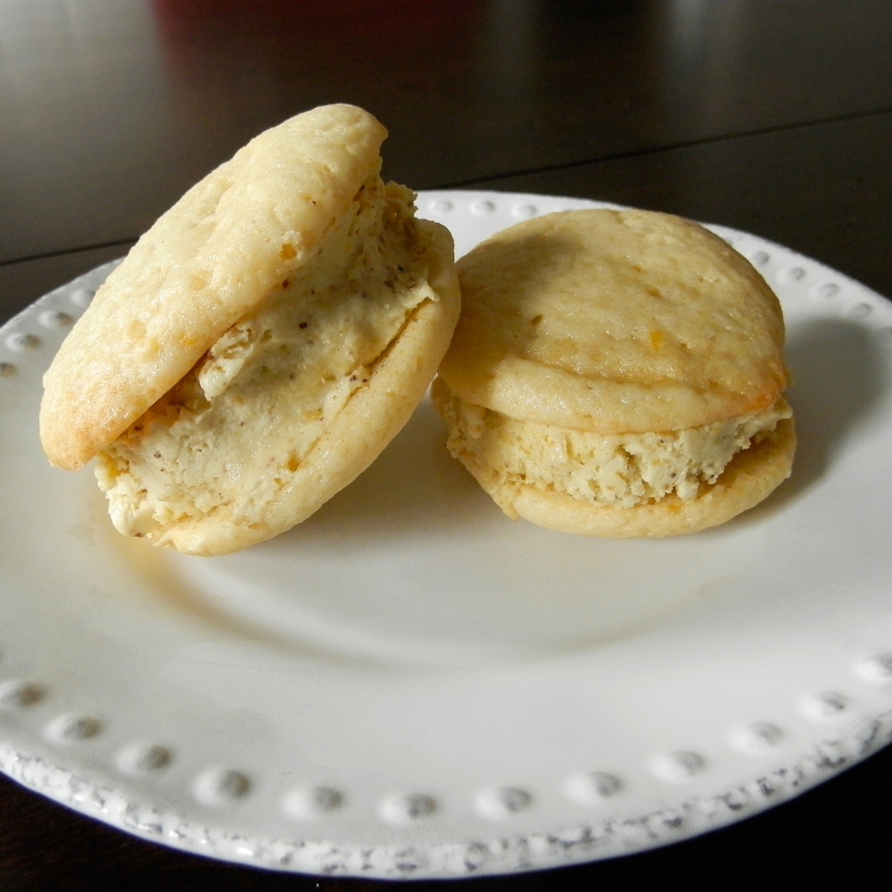 Lemon Pistachio Ice Cream Sandwiches - lemon whoopie pies sandwiched around pistachio ice cream #lemon #icecreamsandwich #pistachio | www.thebatterthickens.com