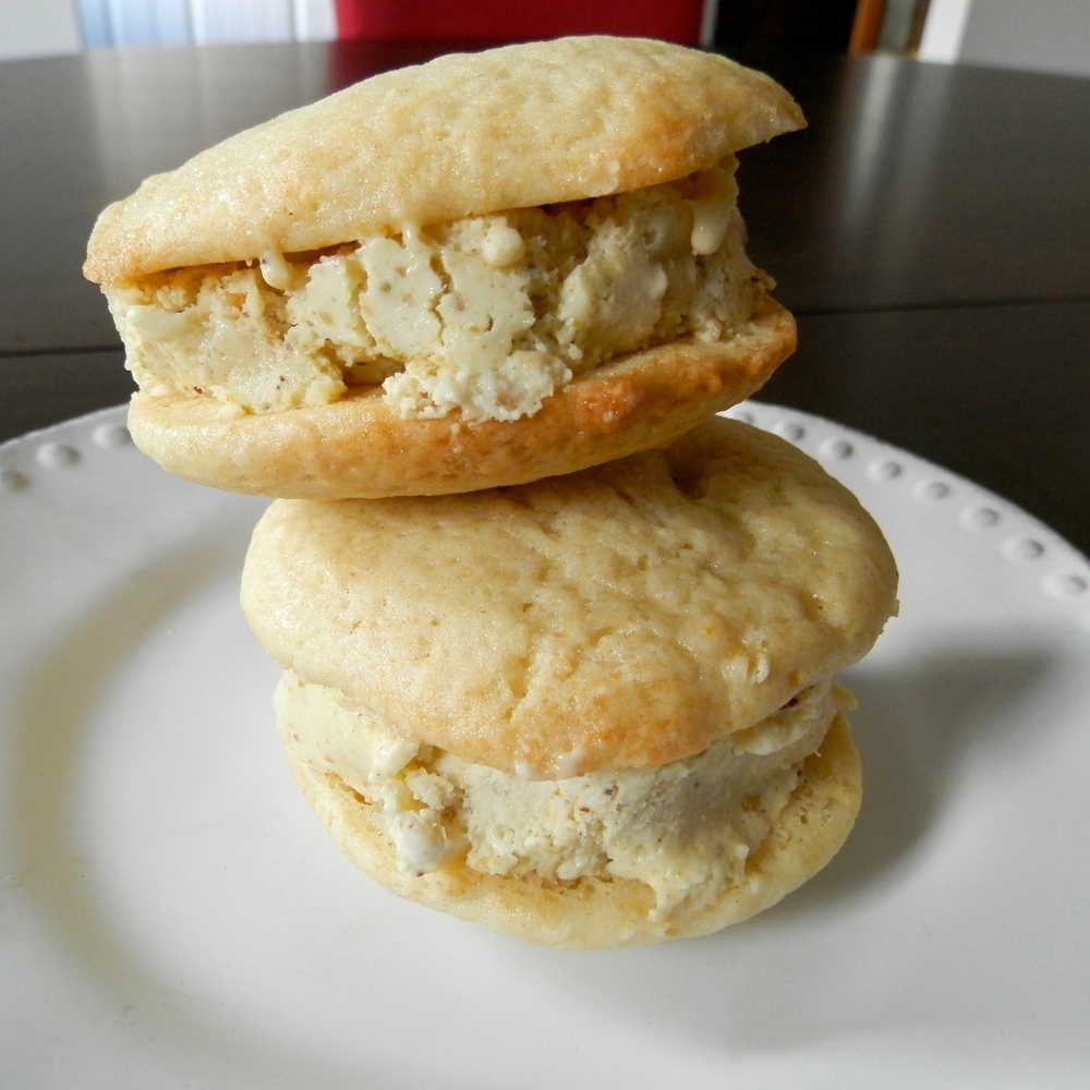 Lemon Pistachio Ice Cream Sandwiches - lemon whoopie pies sandwiched around pistachio ice cream #lemon #icecreamsandwich #pistachio | www.thebatterthickens.com