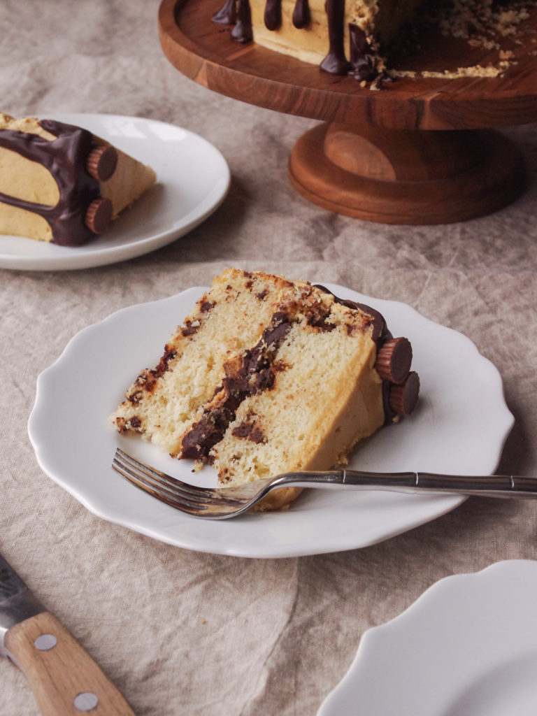 Moose Tracks Cake - white vanilla cake layers with fudgy chocolate ganache, peanut butter frosting, and mini peanut butter cups | www.thebatterthickens.com