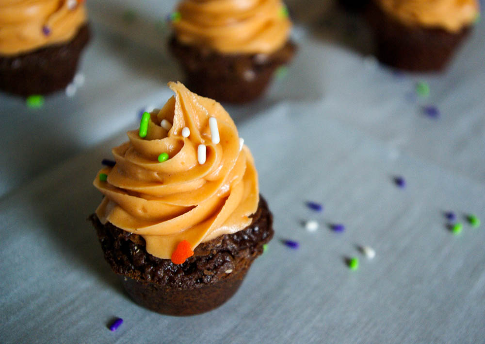 Butterfinger Crunch Brownie Cups - Butterfinger frosting made out of candy corn and peanut butter is a perfect Halloween treat #butterfinger #halloween #brownies | www.thebatterthickens.com