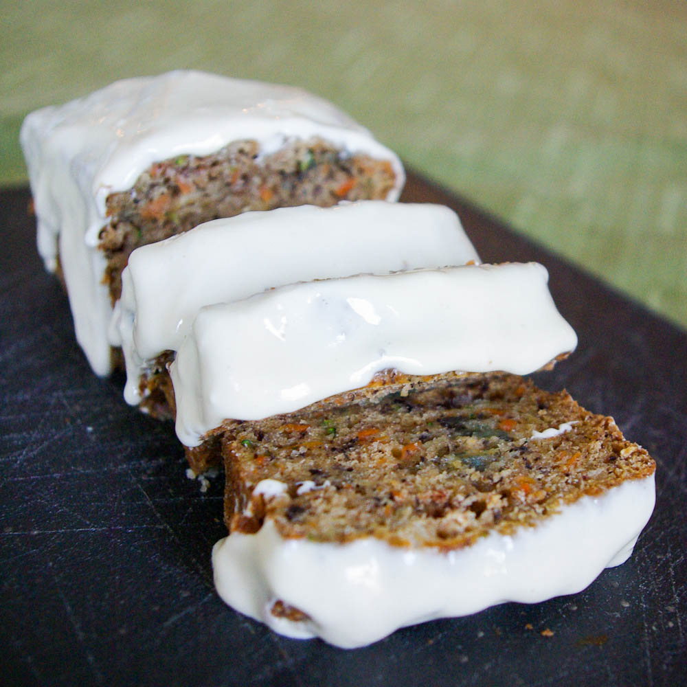 Carrot Zucchini Bread - carrots add an extra sweetness to this moist zucchini bread, topped with luscious maple cream cheese glaze #quickbread #zucchinibread #zucchini #carrot | www.thebatterthickens.com