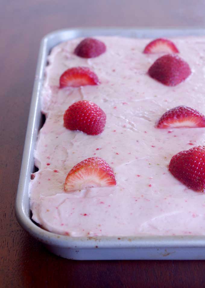 Coconut Carrot Sheet Cake with Strawberry Mascarpone Frosting | A moist carrot cake made with coconut and topped with a sweet, tart strawberry mascarpone frosting | www.thebatterthickens.com