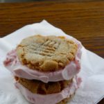 Peanut Butter and Jelly Ice Cream Sandwiches - sweet strawberry ice cream sandwiched between two peanut butter cookies #icecreamsandwich #peanutbutterandjelly | www.thebatterthickens.com