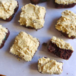 Monster Cookie Brownies - stuffed with peanut butter chips and M&Ms, and covered in peanut butter oatmeal cookie dough frosting #peanutbutter #monstercookies #brownies | www.thebatterthickens.com